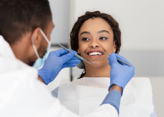 A woman has her teeth cleaned during a general dentistry appointment