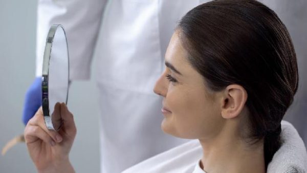 a woman loves the results of her dental bonding treatment